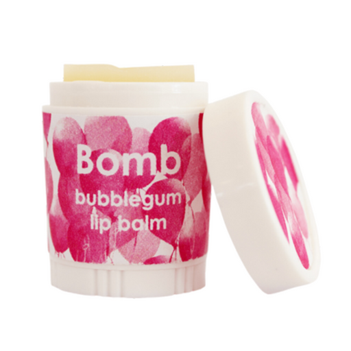 A container of Bomb bubblegum lip balm is shown, featuring a colorful design with pink and red balloon-like patterns. The lid is slightly open, revealing the product inside. The label prominently displays the name "Bomb" along with the description "bubblegum lip balm."