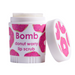 A container of Bomb donut worry lip scrub is shown, featuring a colorful design with pink donut patterns. The lid is slightly open, revealing the product inside. The label prominently displays the name "Bomb" along with the description "donut worry lip scrub."