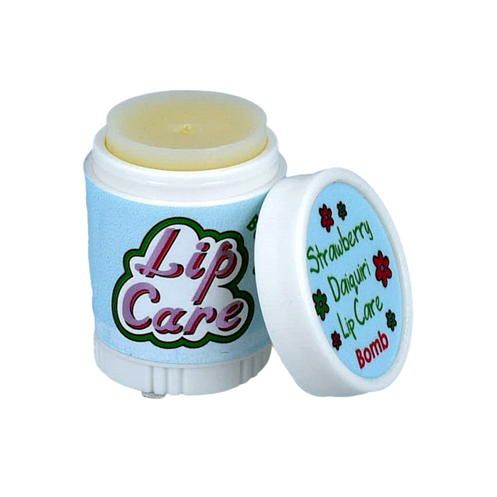 Lip care product in a container featuring a twist-off cap. The container is predominantly light blue with the words "Lip Care" in bold, colorful lettering on the front. The cap is slightly open, revealing a pale yellow lip balm inside. Next to it, a smaller lid displays the text "Strawberry Daiquiri Lip Care Bomb" along with a floral design. The overall design suggests a playful and soothing lip care product.